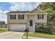 Two-story house with a white garage door and stairs leading to the entrance at 9170 Jefferson Sw Ave, Covington, GA 30014