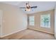 Bright bedroom with two windows, ceiling fan, and carpet at 9170 Jefferson Sw Ave, Covington, GA 30014