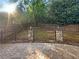 Landscaped backyard with a stone patio and wooden fence at 4060 Willowmere Pointe Nw, Kennesaw, GA 30144