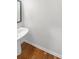 Small powder room with pedestal sink and hardwood floors at 4060 Willowmere Pointe Nw, Kennesaw, GA 30144