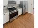 Kitchen boasts stainless steel appliances and granite countertops at 4060 Willowmere Pointe Nw, Kennesaw, GA 30144