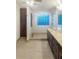 Modern bathroom with walk-in shower, granite countertops, and large mirror at 4060 Willowmere Pointe Nw, Kennesaw, GA 30144