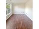 Spacious living room with hardwood floors and large window at 4060 Willowmere Pointe Nw, Kennesaw, GA 30144