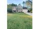 Two-story house with a large front yard, attached garage, and stone accents at 4060 Willowmere Pointe Nw, Kennesaw, GA 30144