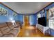 Spacious living room with hardwood floors and brown couches at 903 Bingham Ln, Stone Mountain, GA 30083