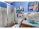 Bathroom with a shower, toilet, and vanity with light blue sink at 903 Bingham Ln, Stone Mountain, GA 30083