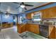 Open kitchen with wood cabinets, granite counters, and stainless steel appliances at 903 Bingham Ln, Stone Mountain, GA 30083