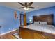 Large bedroom with a wooden bed frame and ceiling fan at 903 Bingham Ln, Stone Mountain, GA 30083