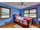 Bedroom with a wooden bed frame and two windows at 903 Bingham Ln, Stone Mountain, GA 30083