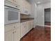 Bright eat-in kitchen with ample cabinetry and hardwood floors at 3680 Windlake Dr, Snellville, GA 30039