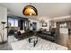 Spacious living room with floor-to-ceiling windows, hardwood floors, and stylish leather sofas at 3107 Peachtree Road Ne Unit #1803, Atlanta, GA 30305