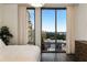 Bedroom with hardwood floors and large windows offering city views at 3107 Peachtree Road Ne Unit #1803, Atlanta, GA 30305