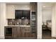 Modern wet bar with wine cooler and granite countertop at 3107 Peachtree Road Ne Unit #1803, Atlanta, GA 30305
