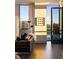 Living area features floor-to-ceiling windows, hardwood floors, and access to a balcony at 3107 Peachtree Road Ne Unit #1803, Atlanta, GA 30305