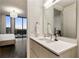 Contemporary bathroom with a vanity and a view into the bedroom at 3107 Peachtree Road Ne Unit #1803, Atlanta, GA 30305