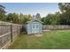 Gray storage shed in a fenced backyard at 79 Russell Ln, Dallas, GA 30157