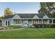 Inviting home with covered porch, neat landscaping, and lush green lawn at 79 Russell Ln, Dallas, GA 30157