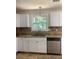 Kitchen features granite counters and new sink at 5364 Cedar Rock Dr, Stonecrest, GA 30038