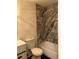 Updated bathroom with grey marble tile shower/tub combo at 5364 Cedar Rock Dr, Stonecrest, GA 30038