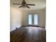 Living room with hardwood floors, ceiling fan and french doors at 5364 Cedar Rock Dr, Stonecrest, GA 30038