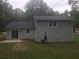 Gray house with back patio and wooded backyard at 5364 Cedar Rock Dr, Stonecrest, GA 30038
