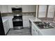 Kitchen with white cabinets, stainless steel appliances and double sink at 41 Ludwick Ln, Lawrenceville, GA 30046