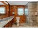 Modern bathroom with glass shower, granite countertop, and wood-paneled walls at 2298 Cole Lake Rd, Dallas, GA 30157
