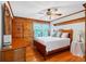 Cozy bedroom with wood walls, hardwood floors, and a ceiling fan at 2298 Cole Lake Rd, Dallas, GA 30157