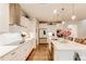 Bright kitchen with white cabinets, quartz countertops, and stainless steel appliances at 230 Mackenzie Ct, Covington, GA 30016