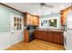 Kitchen with wood cabinets, hardwood floors, and a door to outside at 2263 Winding Way, Tucker, GA 30084