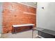 Simple office space with an exposed brick wall and folding tables at 323 Edgewood Se Ave # A, Atlanta, GA 30312