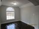 Bright bedroom with dark hardwood floors and arched window at 354 Mansfield Way, Stockbridge, GA 30281