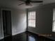 Well-lit bedroom with dark hardwood floors, a ceiling fan, and window at 354 Mansfield Way, Stockbridge, GA 30281