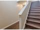 Dark brown wood staircase with white railing and neutral wall color at 770 Galveston Way, Mcdonough, GA 30253