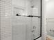 Bathroom with white subway tile shower and a black framed glass shower door at 5530 Aven Rd, Marietta, GA 30068