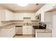 Renovated kitchen, featuring white cabinets and granite countertops at 221 Bentley Pl, Tucker, GA 30084