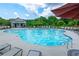 Community pool with plenty of lounge chairs and umbrellas at 2489 Argento Cir, Dacula, GA 30019