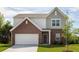 Two-story house with gray siding and brick accents at 2489 Argento Cir, Dacula, GA 30019