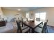 Dark wood dining table with six chairs, adjacent to living room at 2489 Argento Cir, Dacula, GA 30019