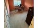 A carpeted bedroom with peach walls and ample space at 220 Lancaster Way, Hiram, GA 30141