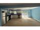 Open concept kitchen with stainless steel appliances and wood-look floors at 8165 Thompson St, Douglasville, GA 30134
