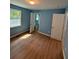Bedroom with wood-look floors, blue walls, and access to bathroom at 8165 Thompson St, Douglasville, GA 30134