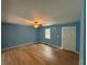 Light and airy living room with light wood floors and blue walls at 8165 Thompson St, Douglasville, GA 30134