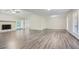 Open living room with hardwood floors and a brick fireplace at 443 Creekwood Pass, Dallas, GA 30157