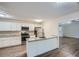 Eat-in kitchen with white cabinets, granite countertops and island at 443 Creekwood Pass, Dallas, GA 30157