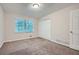 Well-lit bedroom with neutral walls, carpeting and double door closet at 443 Creekwood Pass, Dallas, GA 30157