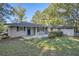 Back of house with patio, yard, and surrounding trees at 443 Creekwood Pass, Dallas, GA 30157