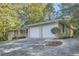 House exterior with two-car garage and landscaping at 443 Creekwood Pass, Dallas, GA 30157