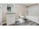 Bathroom with granite countertop, white cabinets, and vinyl flooring at 443 Creekwood Pass, Dallas, GA 30157