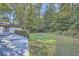 Private backyard with large grassy area and trees at 443 Creekwood Pass, Dallas, GA 30157